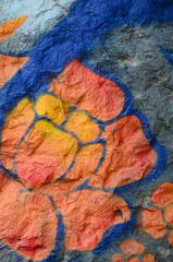 Fragment of graffiti drawings. The old wall decorated with paint stains in the style of street art...