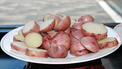 Small sweet potatoes, boiled, sliced and served in a round plate