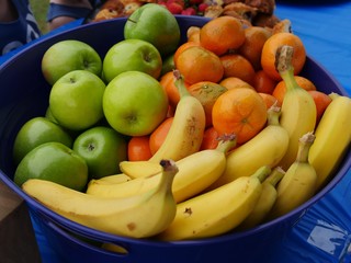 Fresh tropical fruits including orange, green apples, and ripe bananas