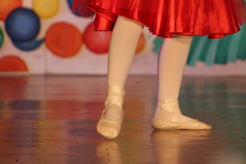 Close up of a graceful young ballerina’s feet dancing on stage