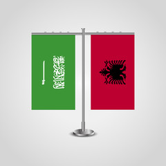 Table stand with flags of Saudi Arabia and Albania.Two flag. Flag pole. Symbolizing the cooperation between the two countries. Table flags
