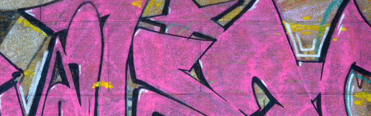 Fragment of graffiti drawings. The old wall decorated with paint stains in the style of street art culture. Colored background texture in purple tones