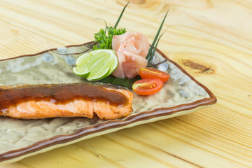 Salmon fillet. Grilled salmon with herb and lemon on black slate board.
