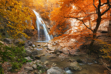 Fototapeta na wymiar Autumn waterfall and rill flow.