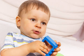 Little child with plastic block, child development concept