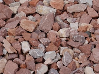 Backdrop of a pile of rocks of different shapes and sizes in a garden
