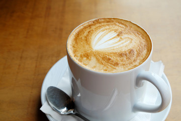 Hot latte on a wooden table