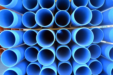 Warehouse of finished plastic pipes industrial outdoors storage site. 
