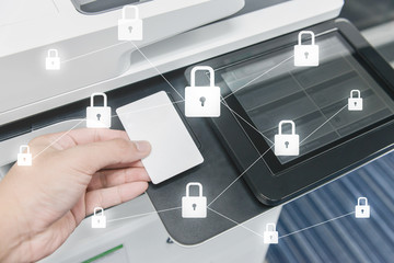 Business man hand is using smart card to printing document with locked key icon for data protection...