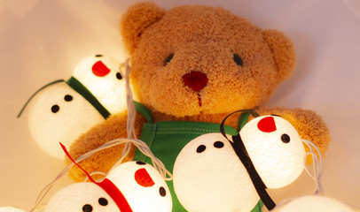 little doll bear and snow doll with the colorful light