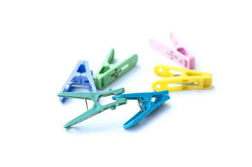 Pile of colorful clothespins isolated on white background