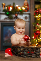 Fototapeta na wymiar Baby boy near christmas tree