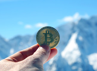 bitcoin money on the hand of a man