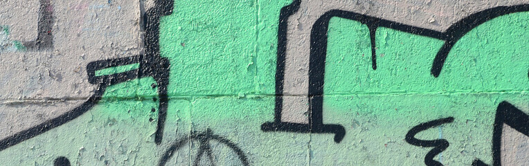 Fragment of graffiti drawings. The old wall decorated with paint stains in the style of street art...