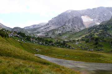 Natural landscape photo of Small wonderful mountain lake Psenodah in North Caucasus near Fisht and Oshten mountains.