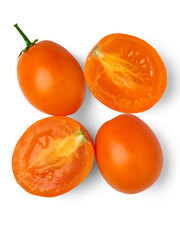 Four yellow tomatoes on a white background. View from above