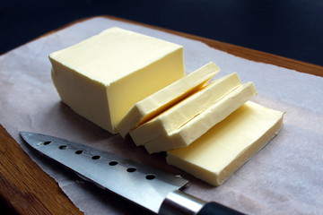 sliced butter lies on a wooden board
