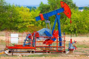 The oil pump, industrial equipment. Oil field site, oil pumps are running. Rocking machines for oil...