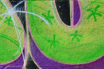 Fragment of graffiti drawings. The old wall decorated with paint stains in the style of street art...