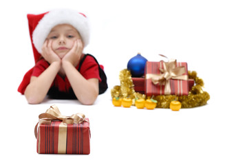 Cute little girl in a Santa Claus cap with Christmas gifts, isolated