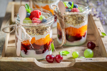 Healthy granola with fresh fruits and yoghurt in jar