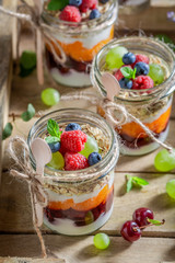 Homemade oat flakes with fresh fruits and yoghurt in jar