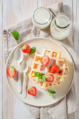 Tasty wafers with powdered sugar and fruits
