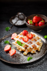 Sweet wafers with strawberries and mint leaves