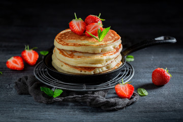 Delicious american pancakes for breakfast on dark table