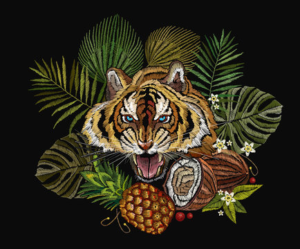 Embroidery tiger in the jungle, palm tree leaves, pineapple, coconut tropical art. Fashionable template for clothes, t-shirt design. Embroidery angry tiger face