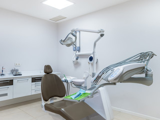 Seat  in a professional and well equipped dental clinic with a moder seat and tools. Dentist specialist concept.