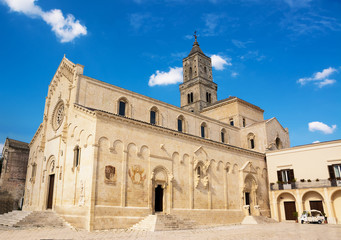 Fototapeta premium church of Madonna della Bruna and Sant'Eustachio, Matera Cathedral and Ape Car for tourists transport