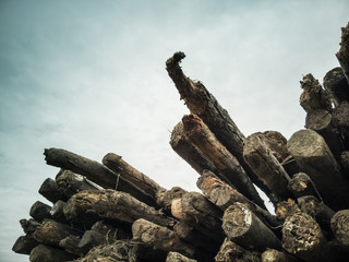 A pile of wood on cloudy sky background