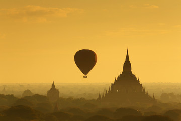  The hot air balloon over plain for tourist and beautiful landscape pagoda ancient with misty morning time of Burma. The landmark tourism culture in Asian.