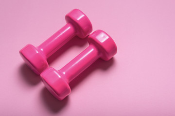 Pair of pink dumbbell on pink color