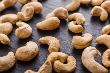 cashew nuts on a dark stone background