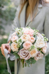 spring mood. Young girl holding a beautiful wedding bouquet. flower arrangement with white and Pastel color flowers.
