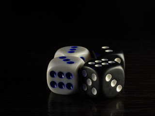 Table gambling with dice and backgammon in the evening with dim light on a dark background