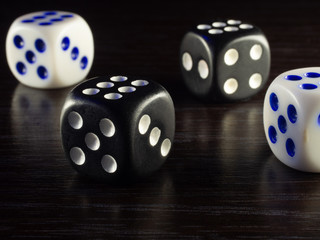 Table gambling with dice and backgammon in the evening with dim light on a dark background