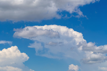 White fluffy clouds in the blue sky background