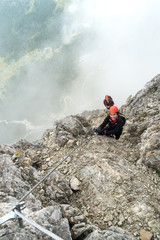 two young attractive female mountain climbers in the Dolomites of italy