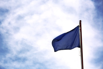 High contrast with blue flag and clear blue sky