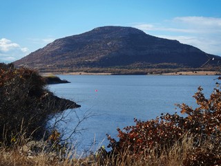 Medium close up of Lake Lawtonka with the 2,464-foot Mt. Scott in the background in the Comanche...