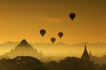 Silhouette of the Tourist Balloon fly over pagoda in the morning on Bagan, Myanmar. Balloon flying is very popular for tourists for pagoda sightseeing