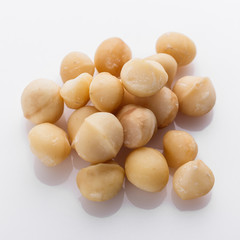 delicious macadamia nuts on a white acrylic background