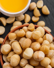 delicious macadamia nuts on a dark stone background