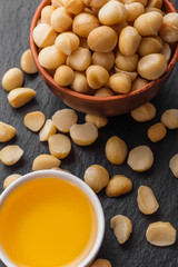 delicious macadamia nuts on a dark stone background