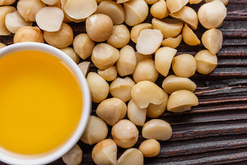 delicious macadamia nuts on a wooden rustic background