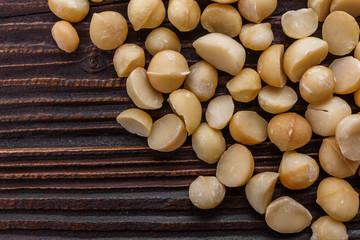 delicious macadamia nuts on a wooden rustic background