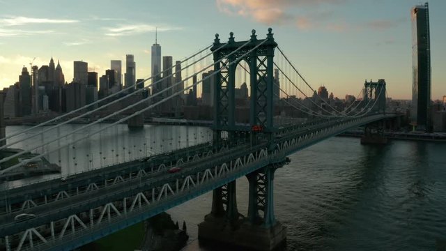 flying alongside Manhattan Bridge towards sunset view of NYC